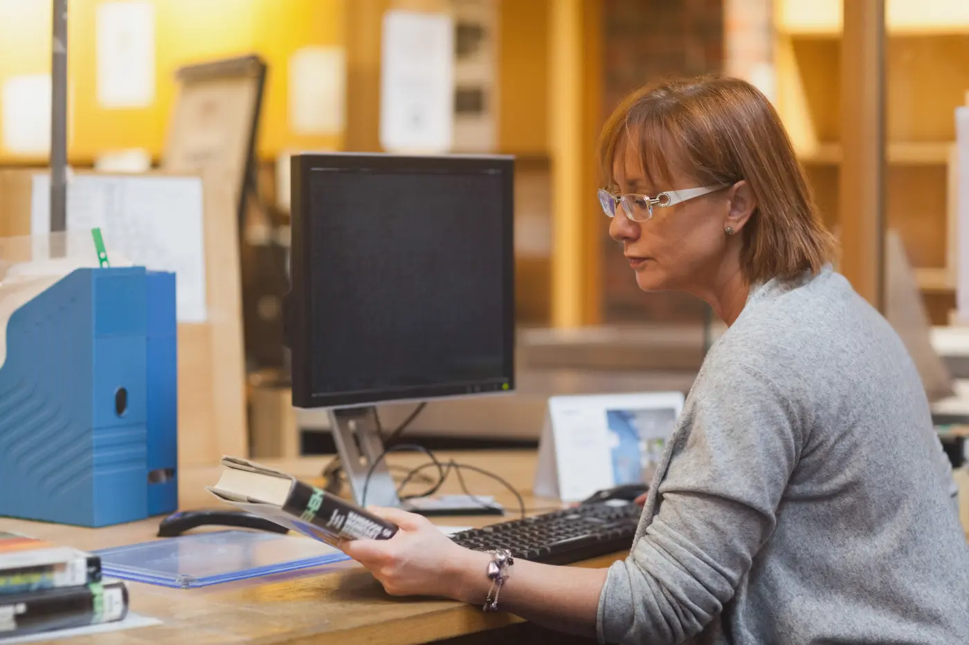 Customer reviewing printed material while considering output-quality requirements