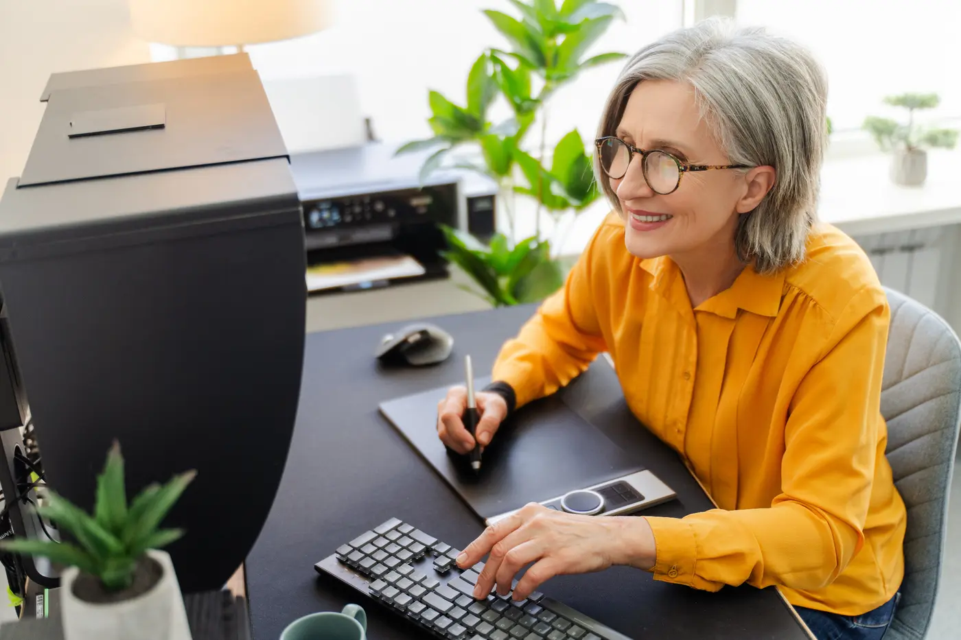 Customer working beside a printer while reviewing a more dependable replacement
