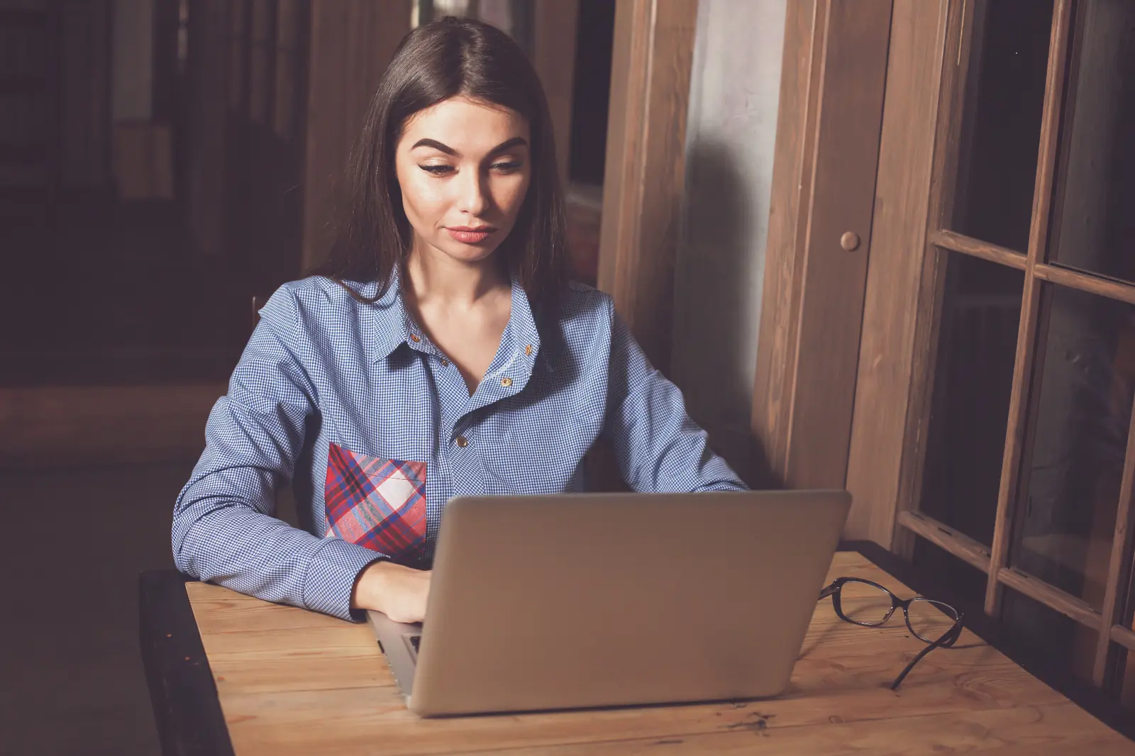 Professionals using laptop computers in a modern office