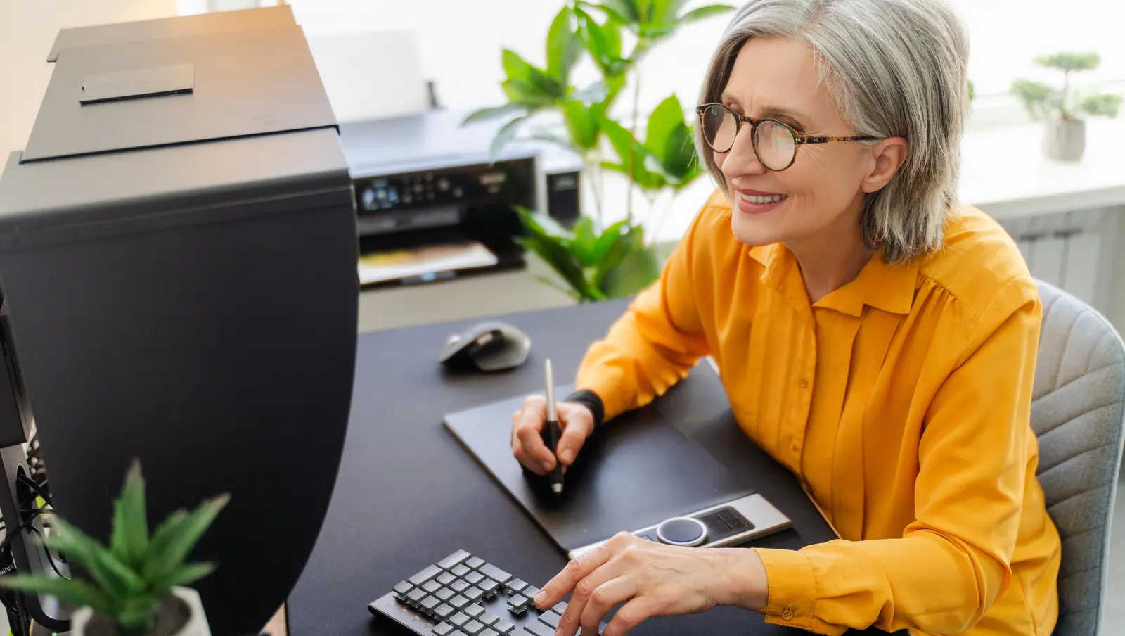 Customer reviewing computer and printing requirements in a modern workspace